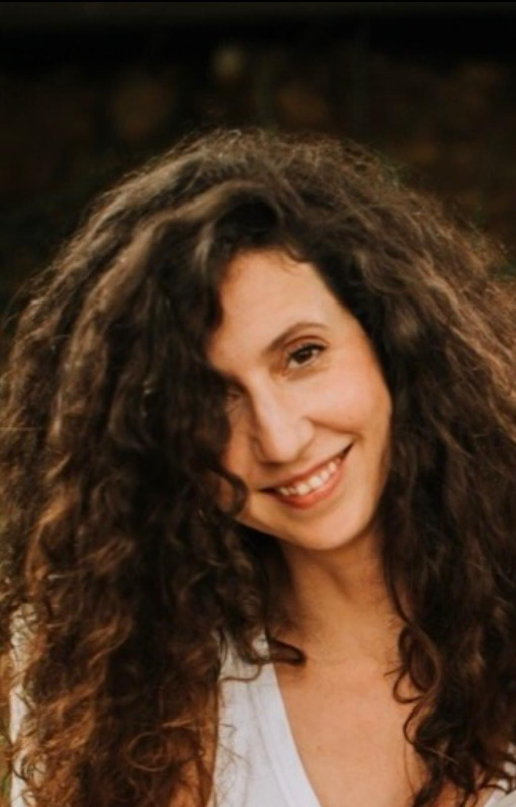 Joana A. Portela, Owner's Representative, smiling outdoors