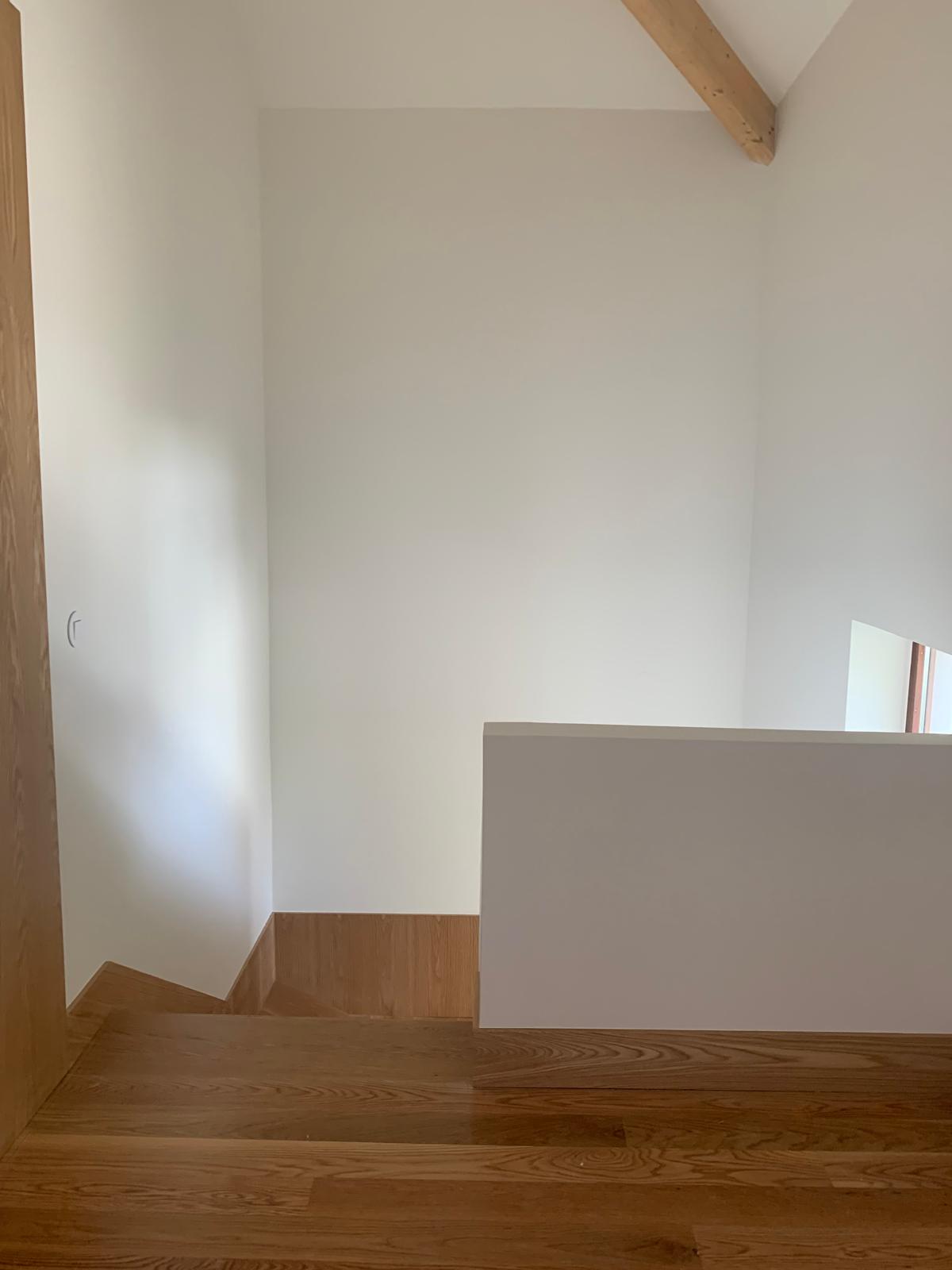 Upper landing with pitched ceiling, exposed beam and solid oak flooring