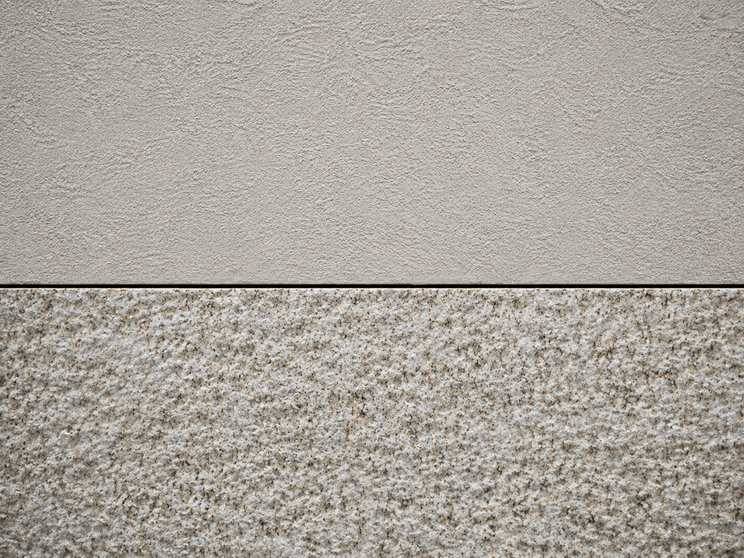 Detail of new render meeting a bush-hammered granite plinth on a Porto facade